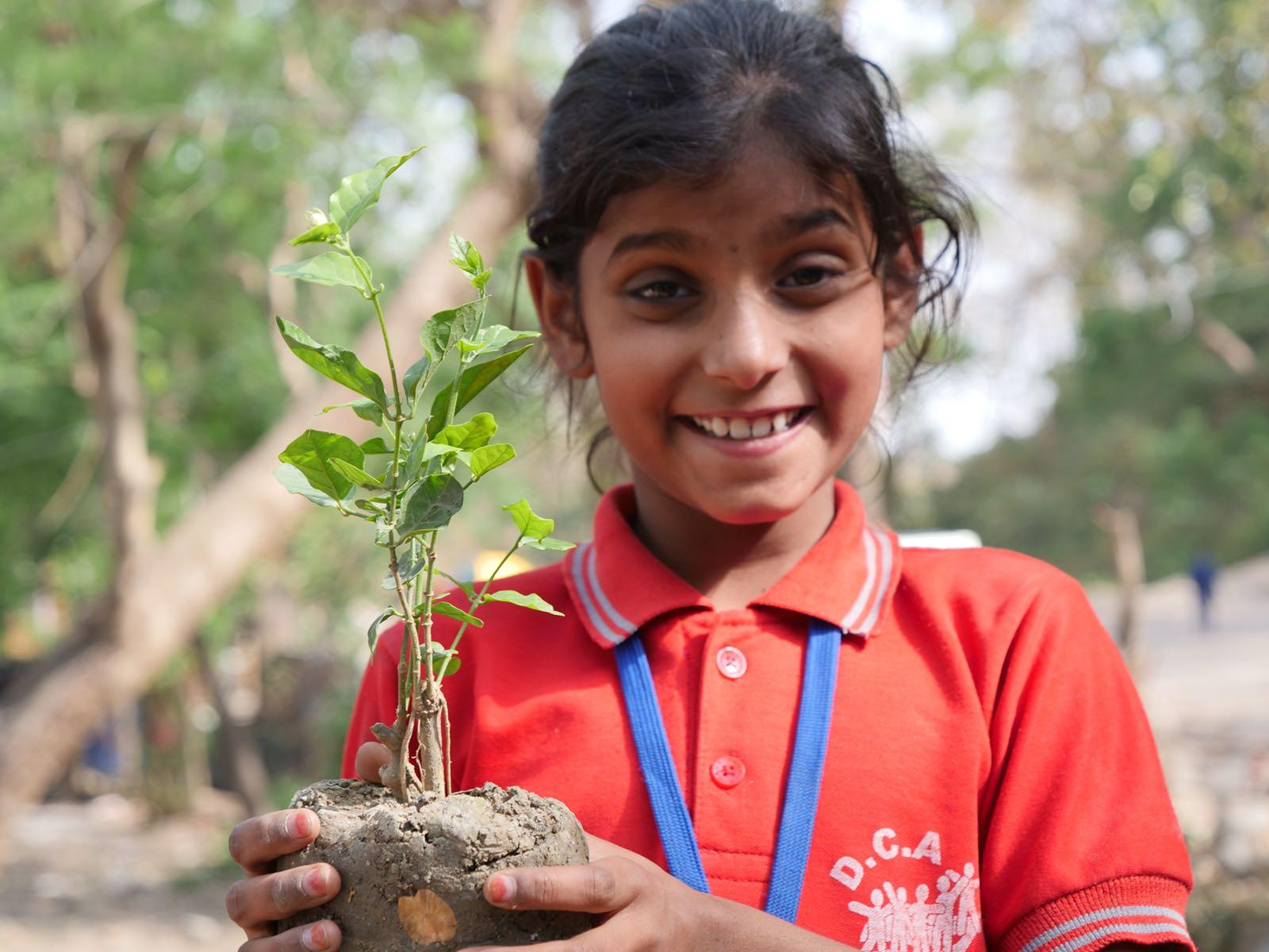 Indian girl planting trees