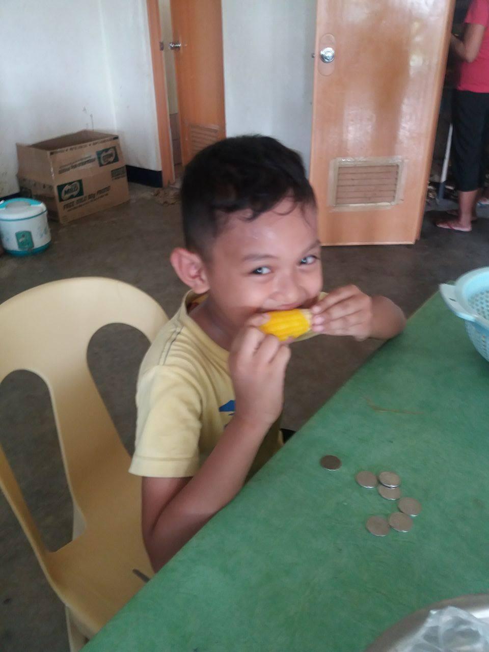 Child eating Mais Philippines