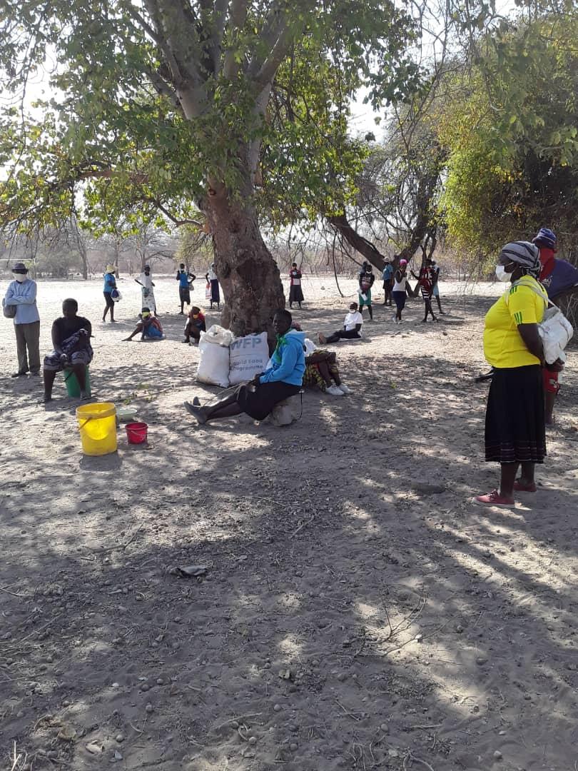 Parents wait for food ration at school site